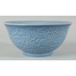 A CHINESE POWDER BLUE GLAZE PORCELAIN BOWL, the exterior with carved dragon, six-character mark to