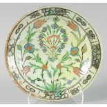 A FINE EARLY 17TH CENTURY OTTOMAN TURKISH IZNIK DISH, painted with central floral spray, 31cm