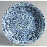 A LARGE CHINESE YUAN STYLE BLUE AND WHITE PORCELAIN CHARGER, painted with panels of phoenix and