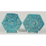 A PAIR OF 13TH CENTURY PERSIAN SELJUK GLAZED POTTERY HEXAGONAL TILES, with raised floral motif