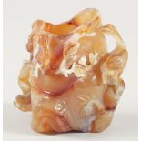 A CHINESE CARVED AGATE BRUSH WASH, the body beautifully relief-carved with animals, branches and