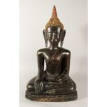 A LARGE TIBETAN SEATED BRONZE BUDDHA with gilded head piece, 77cm high.