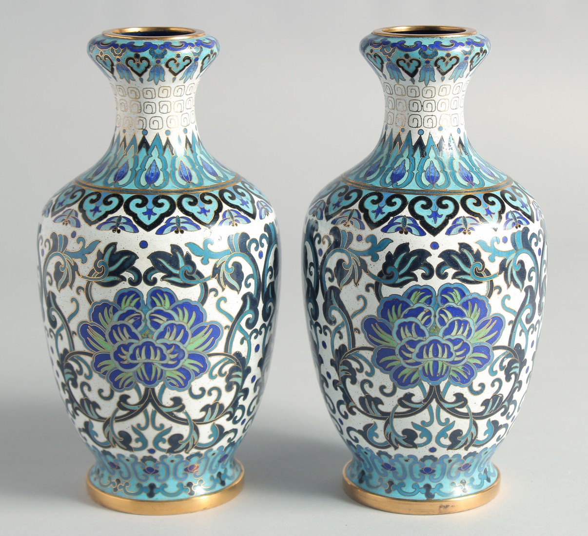 A GOOD PAIR OF BLUE, WHITE AND GREEN CLOISONNE VASES, decorated with intertwined foliate design with