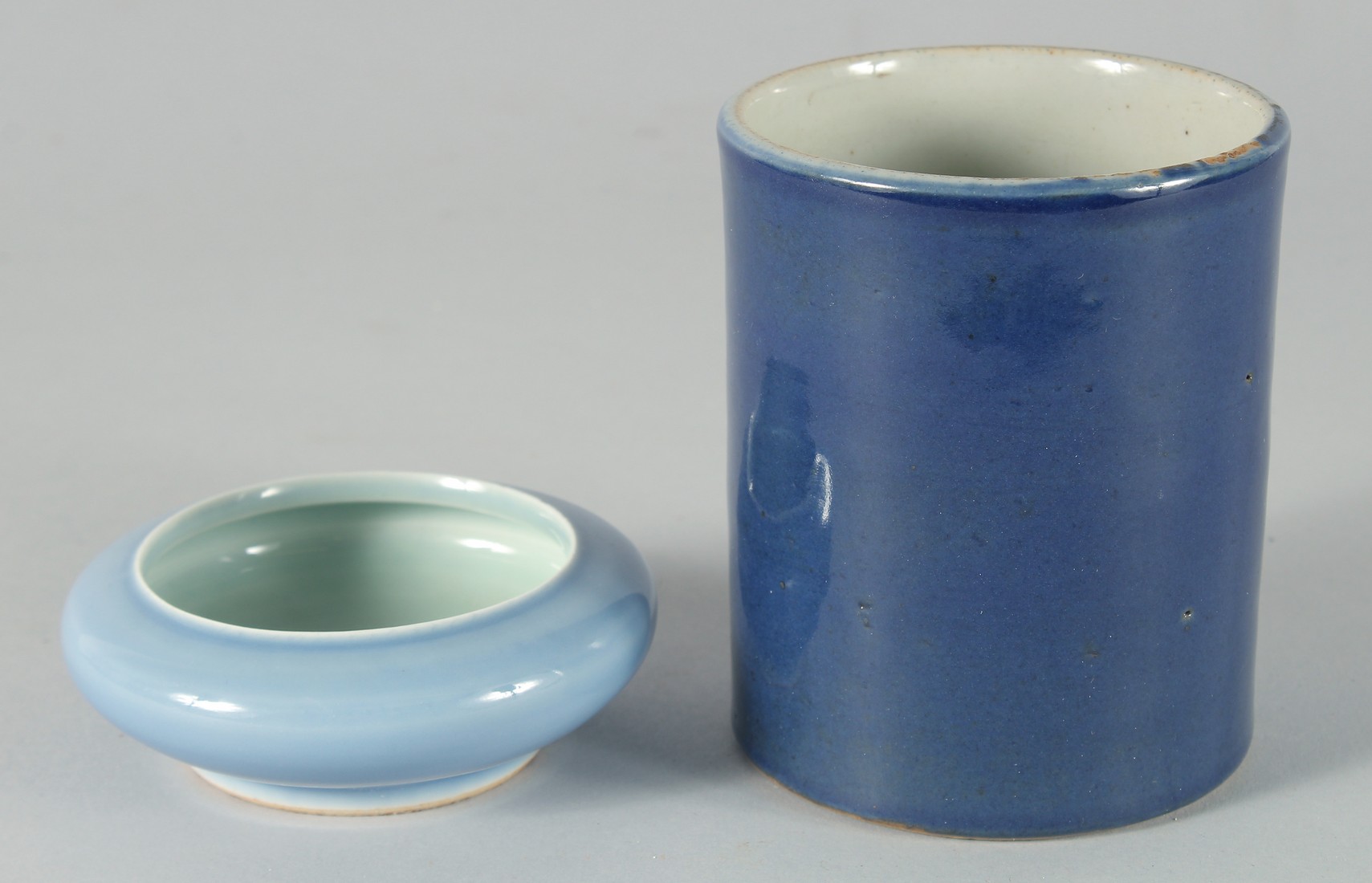 A CHINESE POWDER BLUE PORCELAIN BRUSH WASHER, the base with six-character mark, 10cm diameter,