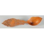 A 19TH CENTURY PERSIAN QAJAR CARVED FRUIT WOOD SHERBET SPOON, 28cm long.