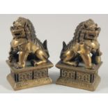 A SMALL PAIR OF BRONZE TEMPLE LIONS, 10.5cm high.