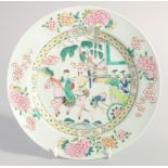 A CHINESE FAMILLE ROSE PORCELAIN PLATE, painted with a figure on horseback with a floral border,