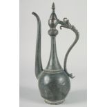 A 16TH CENTURY SAFAVID TINNED COPPER EWER, with hinged lid and curved handle terminating in an