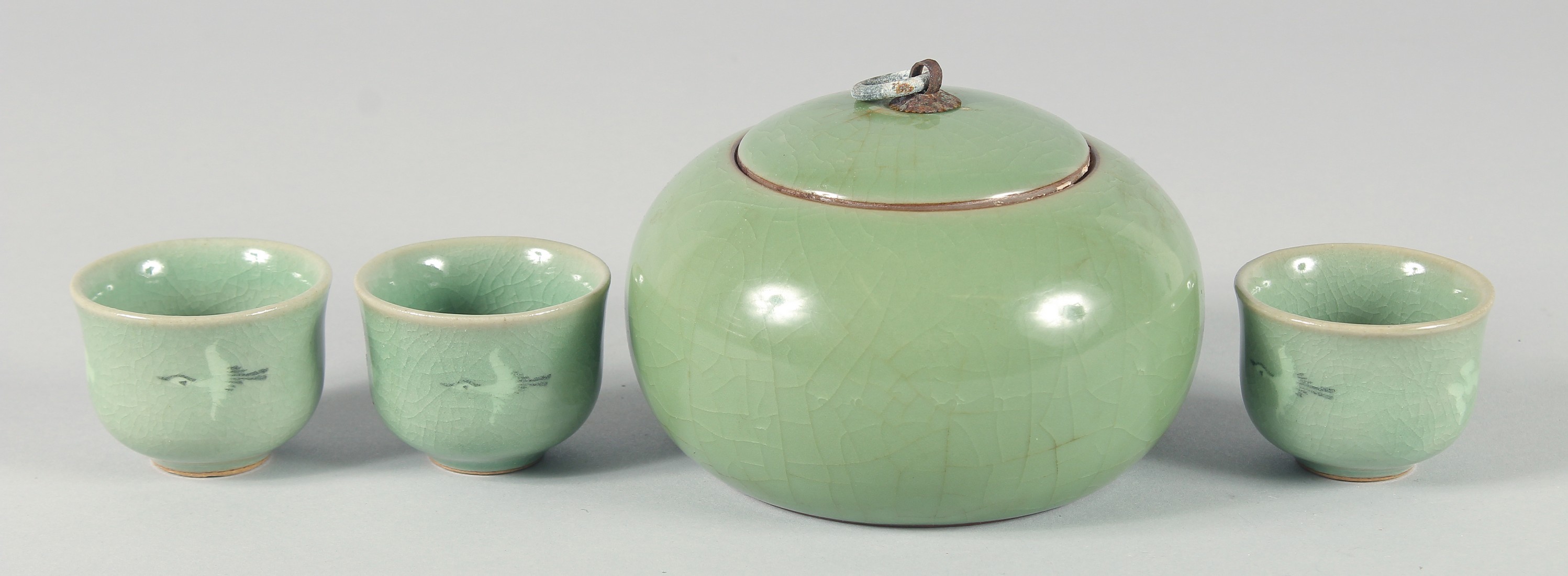 A CELADON CRACKLE GLAZED JAR AND COVER, together with three Korean cups, (4).