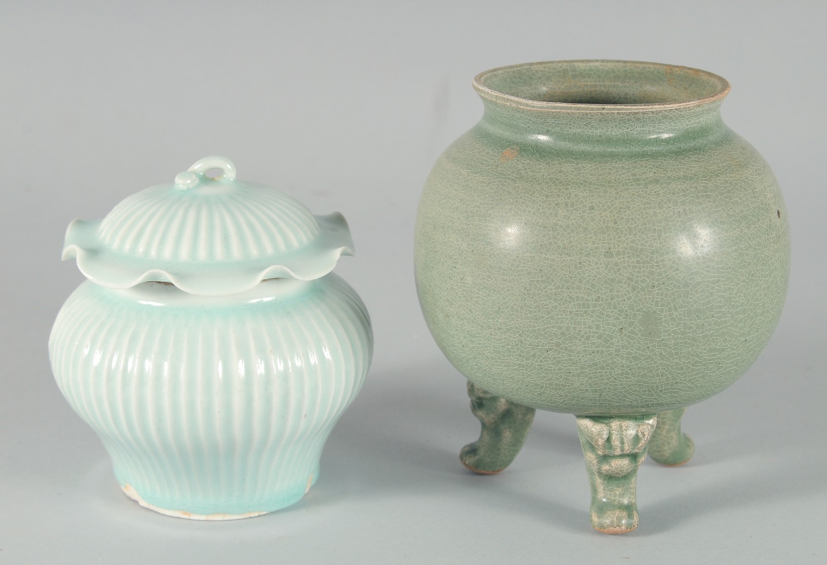 A CHINESE CELADON GLAZE POTTERY BOWL, raised on three moulded legs, 15cm high, together with a small