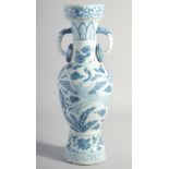 A CHINESE YUAN STYLE BLUE AND WHITE GLAZED POTTERY TWIN HANDLE VASE, painted with birds and flora,