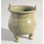 A CHINESE LONGQUAN CELADON TRIPOD CENSER, with carved foliate decoration, 15.5cm high.