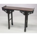 A CHINESE ROSEWOOD ALTER TABLE, the panelled rectangular top with curving ends, on stretchered