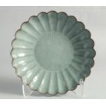 A CHINESE CELADON CRACKLE GLAZE RIBBED CIRCULAR DISH, 24cm diameter.