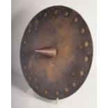 A 19TH CENTURY INDIAN SHIELD with large central spike, likely for a chariot wheel, 50.5cm diameter.