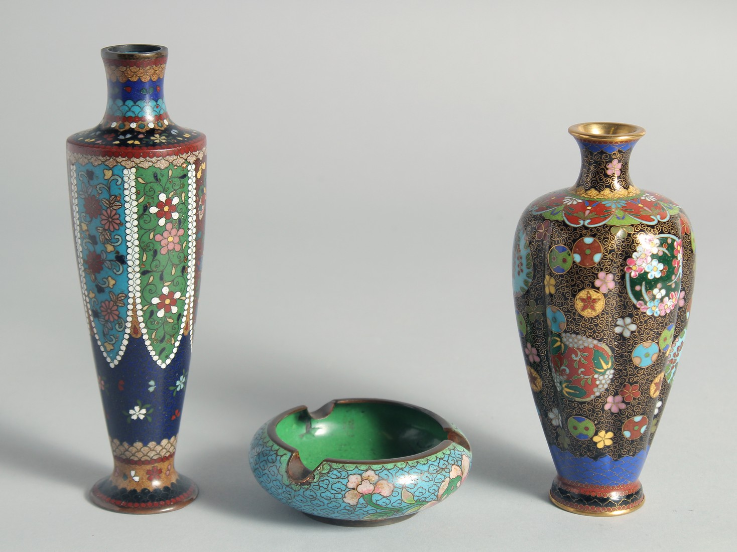 TWO SMALL JAPANESE CLOISONNE VASES, each decorated with floral motifs, 18cm and 15.5cm, together