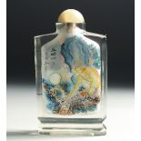 A CHINESE REVERSE PAINTED GLASS SNUFF BOTTLE with hardstone stopper, decorated with a monkey to