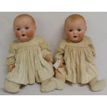 Pair of Armand Marseille bisque socket head dolls marked "AM Germany 518 / 6 1/2 K" on bent limb