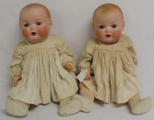 Pair of Armand Marseille bisque socket head dolls marked "AM Germany 518 / 6 1/2 K" on bent limb