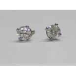 Pair of diamond stud earrings set in white gold, the butterflies marked 750, approximately 0.24ct