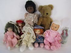 Collection of vintage dolls and a teddy bear