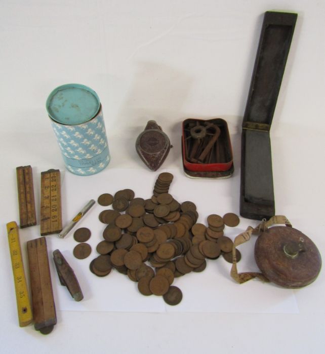Collection of old pennies and small tools