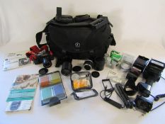 Canon T70 Camera with Sunpak Thyristor auto zoom 3600,  Canon and Teleplus lens, filter kit and