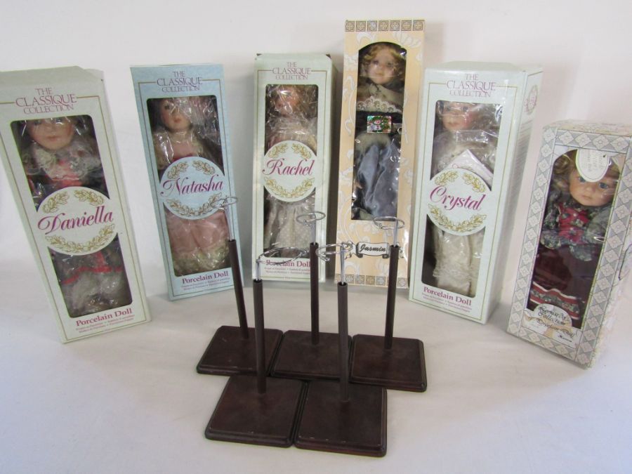 Collection of collectors boxed porcelain dolls with stands