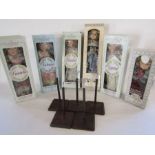 Collection of collectors boxed porcelain dolls with stands