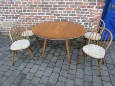 Ercol drop leaf round dining table and 4 Windsor dining chairs with original Ercol popper cushions