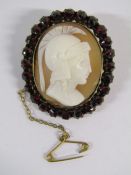 Roman Centurion cameo brooch in yellow metal mount with garnet surround, some damage to bottom of