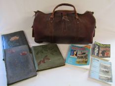 Leather holdall, empty vintage postcard albums and postcard reference books