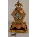 Ornate ormalu French clock on stand Ht 33cm