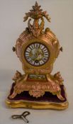 Ornate ormalu French clock on stand Ht 33cm