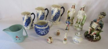 Collection of ceramics to include a pair of flatbacks, Burslem jugs, a Wade water jug and others -