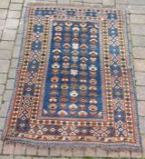 Persian carpet blue ground with red and cream design approx. 163cm x 116cm