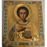 Russian icon of St Panteleimon with gilded metal work decoration. Size 31cm by 27cm. Provenance: The