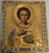 Russian icon of St Panteleimon with gilded metal work decoration. Size 31cm by 27cm. Provenance: The