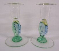 #### Amended description. A pair of Helen Millard clear and coloured glass fish candlesticks (one