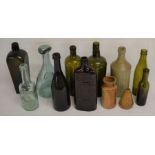 Collection of vintage glass bottles including Warner's Safe Cure, a seal bottle, box moulded