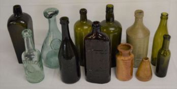 Collection of vintage glass bottles including Warner's Safe Cure, a seal bottle, box moulded