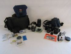 An Olympus SP-700 compact digital camera, Canon EOS 1000F film camera with case and Canon  EOS 300