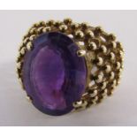 9ct gold ring with oval step cut amethyst approx. 6.5ct 4 claw setting, beaded design shoulders -