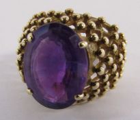 9ct gold ring with oval step cut amethyst approx. 6.5ct 4 claw setting, beaded design shoulders -