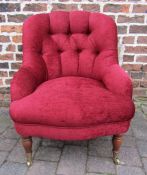 Red material button backed tub chair with front castors