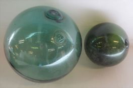 2 large green glass floats/buoys. Largest with a diameter of approx 39cm