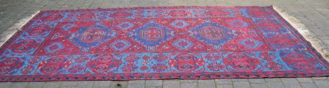 Flat woven Persian Kilim Soumak wool carpet in a red ground 384cm by 215cm