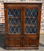 Oak display bookcase with linen fold panels & leaded glass Ht 138cm W 97cm D 32cm