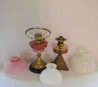 Two late 19th/early 20th century paraffin lamps with 3 shades plus a hanging paraffin lamp