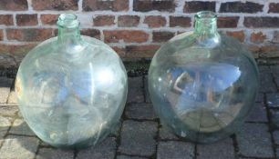 2 large green glass carboys. Approximate height 53cm width 40cm